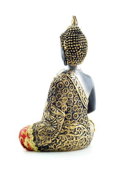 Portrait of a golden white of a Buddha in soft and bright ambience with copy space on the right side for mindfulness and wisdom concepts.  Selective focus and added grain. Part of a series.