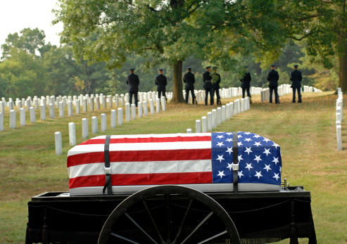 a caisson draped with flag awaits Arlington burial