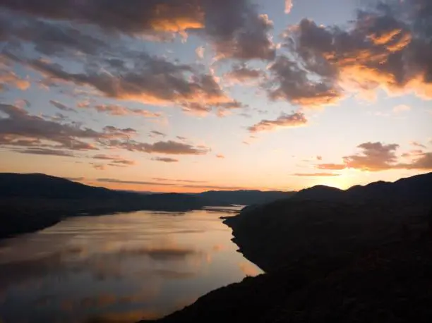 The setting sun at Kamloops in evening overlooking lac du bois grasslands and thompson river.