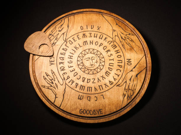 Ouija Board, yellow on a black background stock photo