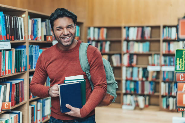 istock Cheerful student with a bunch of books 1159871734