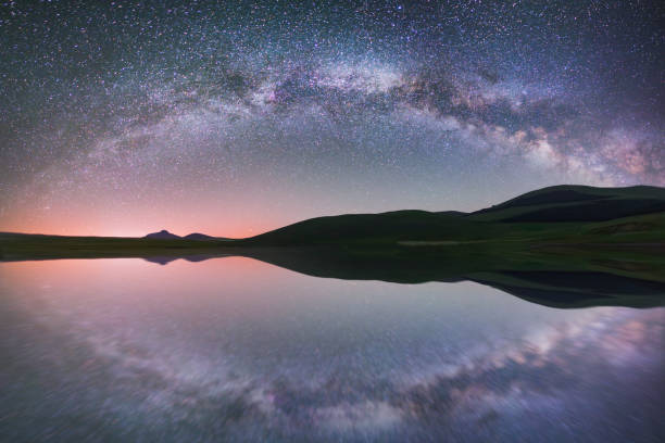 istock Beautiful panoramic milky way galaxy with reflection over the lake 1159873962