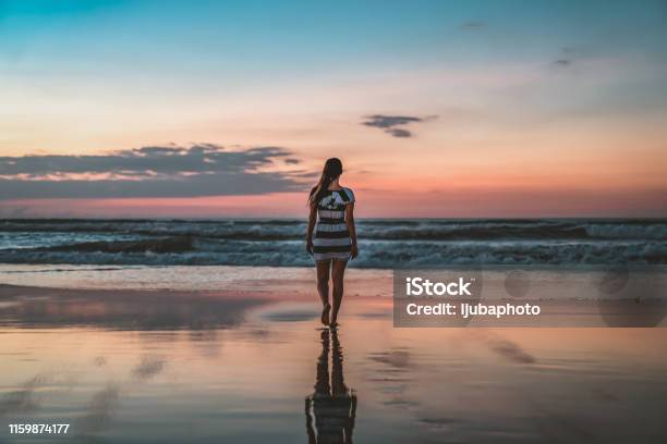 Walking Into Sunset Stock Photo - Download Image Now - Seminyak, Bali, Beach