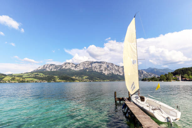 View to lake Attersee with sailing boat, Mountains of austrian alps near Salzburg, Austria Europe View to lake Attersee with sailing boat, Mountains of austrian alps near Salzburg, Austria Europe attersee stock pictures, royalty-free photos & images