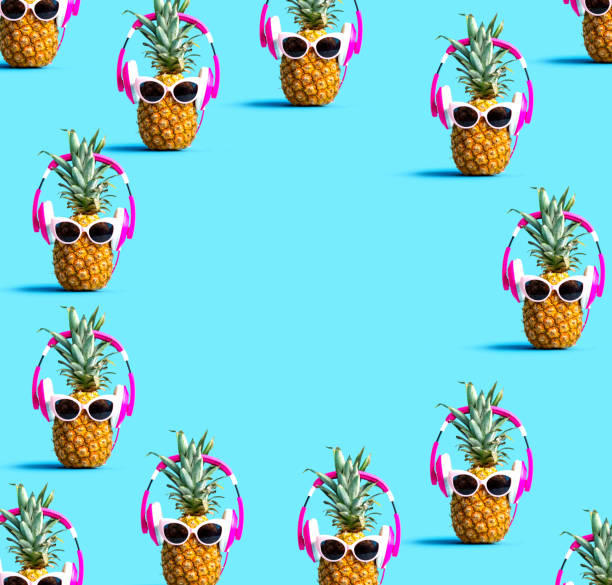 istock Round frame of pineapples wearing headphones 1159875795
