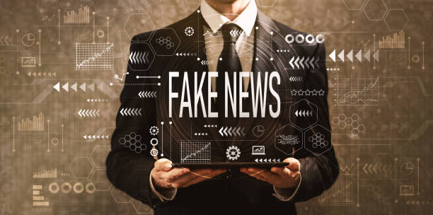 istock Fake news with businessman holding a tablet computer 1159875935