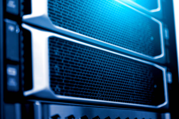 istock Server rack close up meshed hard drive cover blurred frame depth of field fluorescent blue light 1159876027