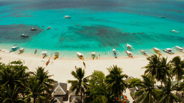 istock Tropical Daco Island with a sandy beach and tourists 1159878603