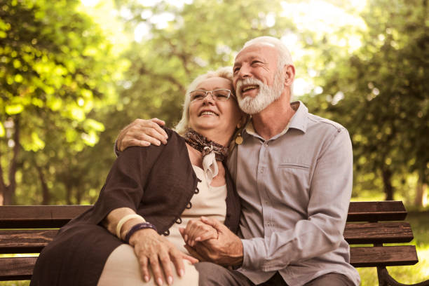 istock Senior couple relaxing outdoors in park 1159879324