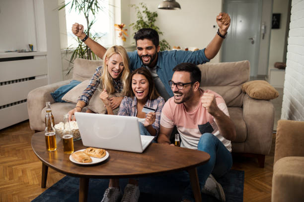 Friends cheering for their team and betting online