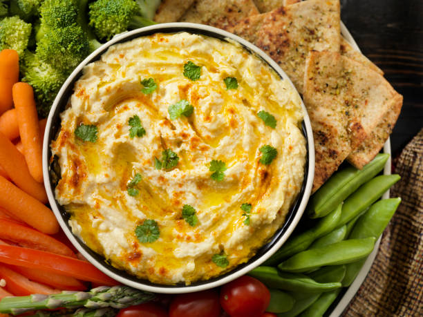 istock Roasted Garlic Hummus with Veggies and Pita Chips 1159882233