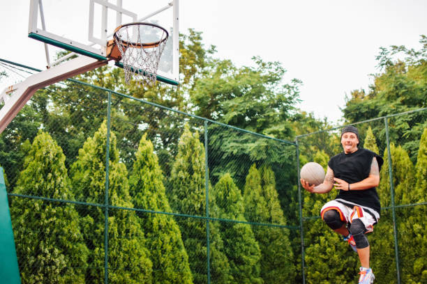 istock Streetball player shoots basket 1159885203