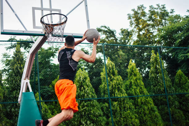 istock Streetball player shoots basket 1159885961