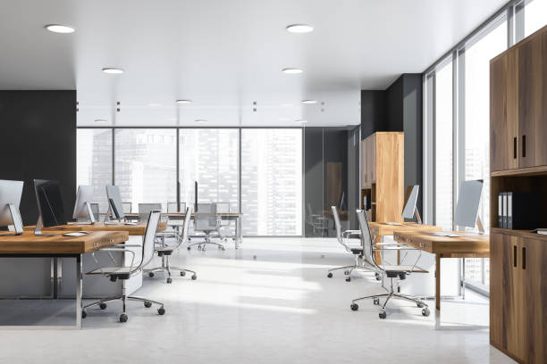 istock Panoramic open space office with wooden desks 1159886538