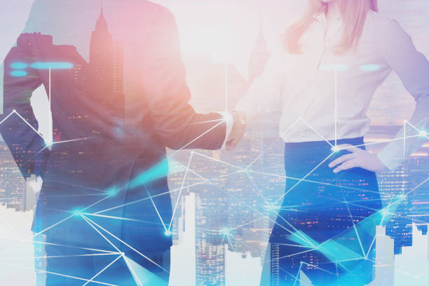 istock Man and woman shaking hands, digital network 1159887685