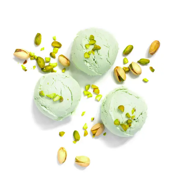 Three balls of pistachio ice cream on the white background, top view