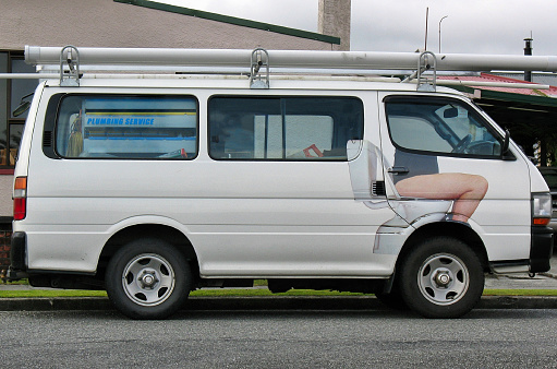 Funny plumber's truck with man sitting on toilet, taken in New Zealand
