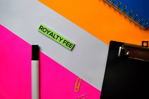 istock Royalty Fee text on sticky notes with color office desk concept 1159903424