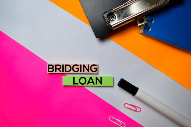 istock Bridging Loan text on sticky notes with color office desk concept 1159903646