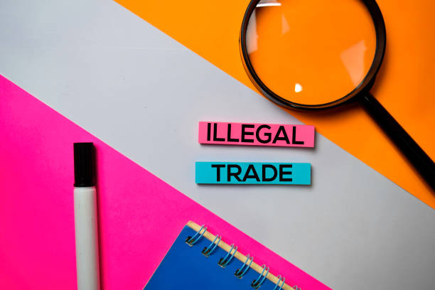 istock Illegal Trade text on sticky notes with color office desk concept 1159903962