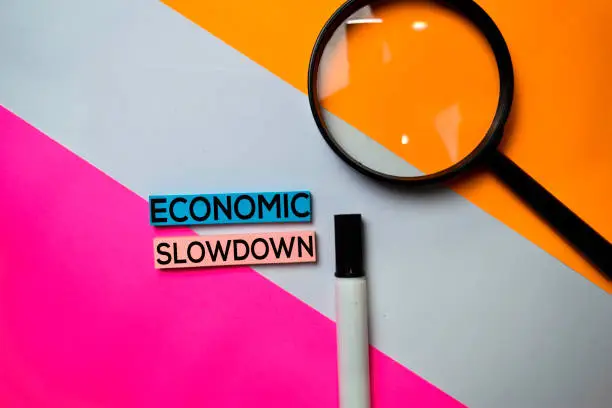 Photo of Economic Slowdown text on sticky notes with color office desk concept