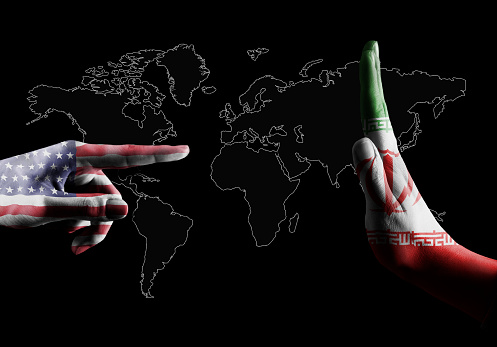 Fore finger with USA flag pointing in hand stop sign with IRANIAN flag / Flag concept (Click for more)