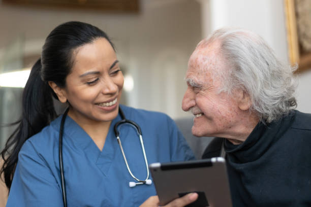 istock Elderly Gentleman With Nurse During Home Care Visit 1159909350