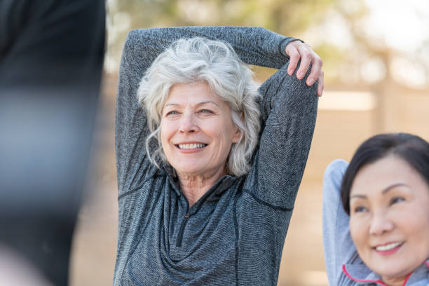 istock Senior Best friends Stretching Outside 1159909461