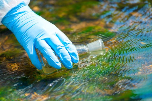 istock close up of a scientist's river drawing water into a research flask from a stream 1159909470