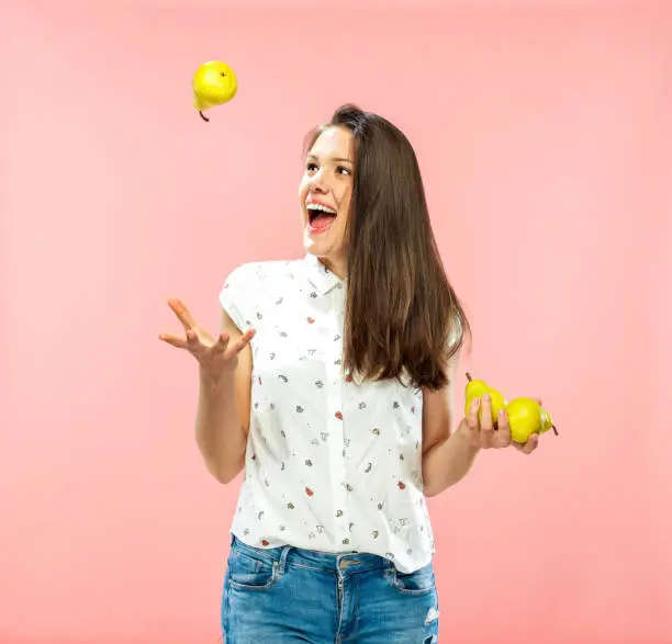 Cheerful Young Adult Playing with Pears.
