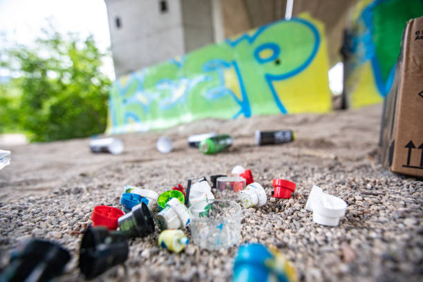 istock Used Spray Caps Lying on the Floor after Finishing a Graffiti 1159912370