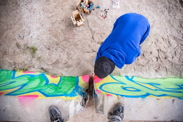 istock Spraypainting a Concrete Wall from Directly Above 1159912380