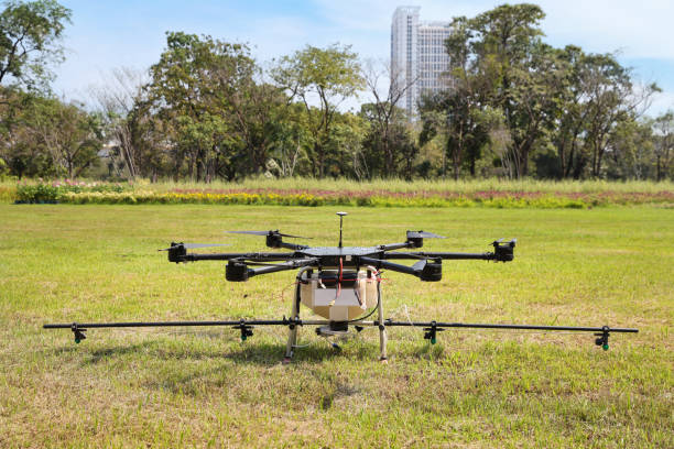 istock drone on green grass for sprinkle water from the air for causing dust to drop and reduce PM 2.5 in Thailand 1159916050
