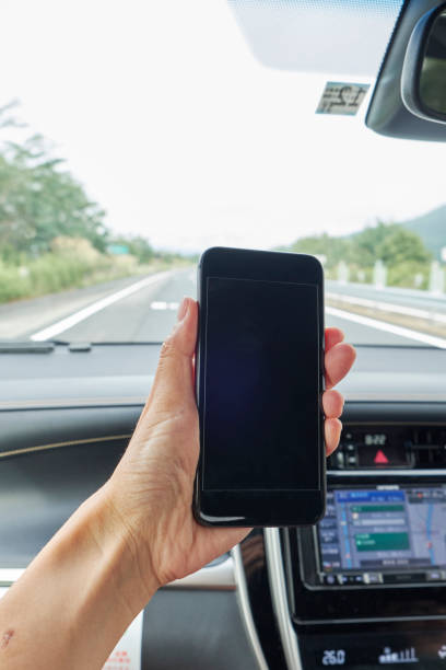 istock Car driving and smartphone 1159924251