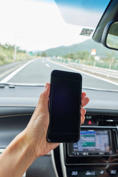 istock Car driving and smartphone 1159924254