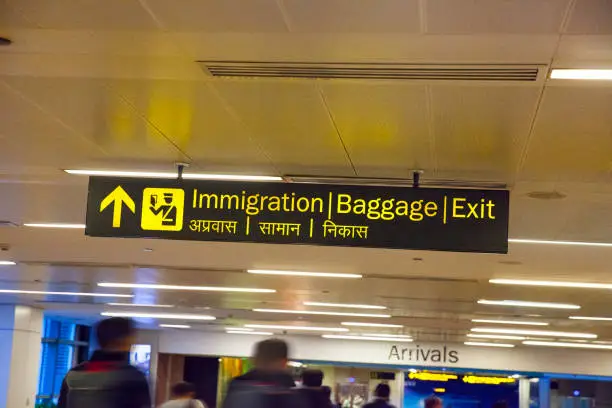 Immigration and Baggage signs at the Arrival hall in Indira Gandhi International Airport in New Delhi, India