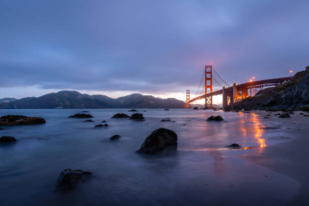 Sunrise from Marshall Beach Dawn breaks over the Golden Gate Bridge from Marshall Beach in San Francisco west marin stock pictures, royalty-free photos & images