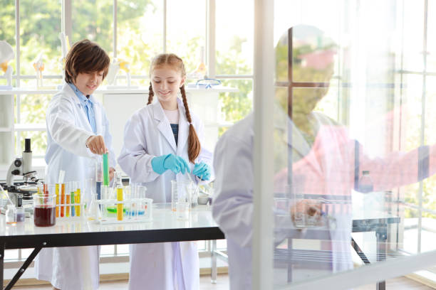 istock happy kids boy writing math formulas on glass in class room (education and scientist concept) 1159934869