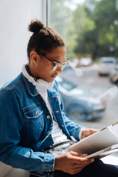 istock Concentrated male person reading book during break 1159936616