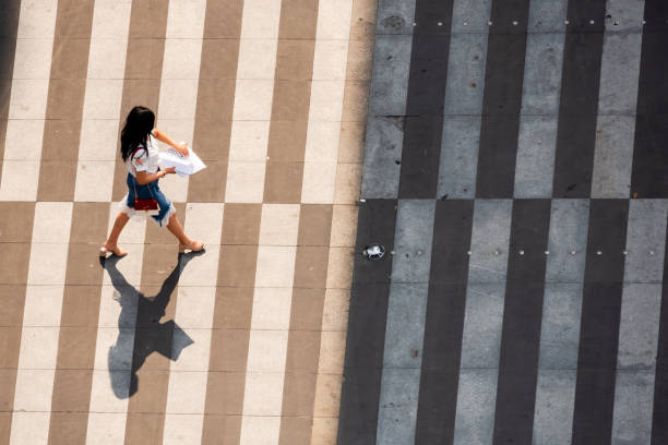 Young chinese woman walking on a zebra crossing stock photo