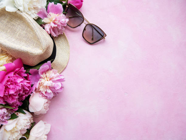 istock Pink peonies and hat on a pink concrete background 1159946302