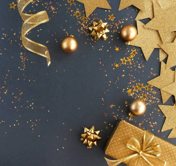 istock christmas or new year frame decorations in gold colors on dark blue background with empty copy space for text. holiday and celebration concept for postcard or invitation. top view 1159947294