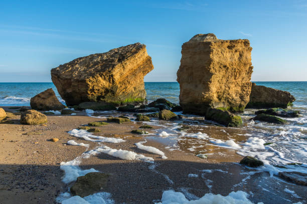 istock Several huge limestone stones by the sea 1159947309