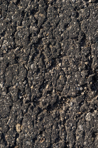 istock Macro texture of old cracked asphalt 1159948007