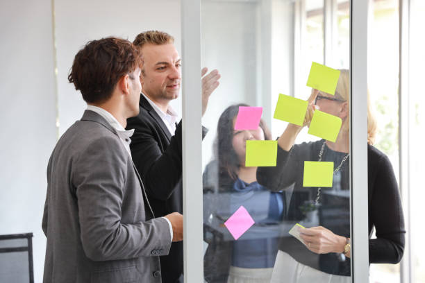 istock multiethnic business people using post it notes for brainstorming or sharing idea in new project meeting 1159948806