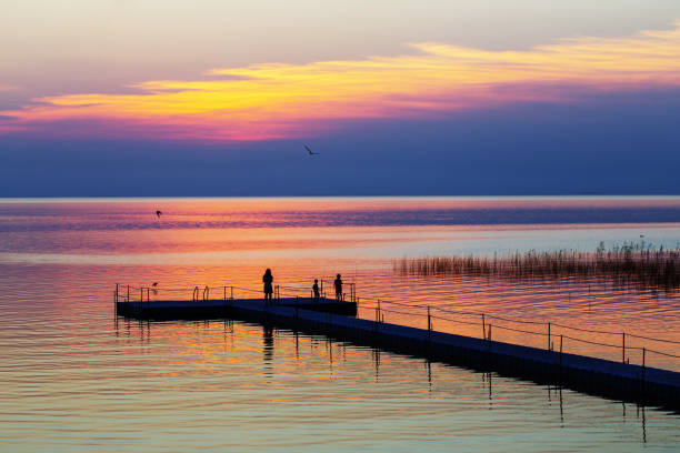 istock family on pontoon pier at sunset 1159950142