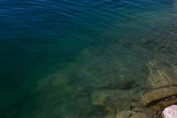 istock Texture of water surface sun water stones waves - underwater world 1159950295