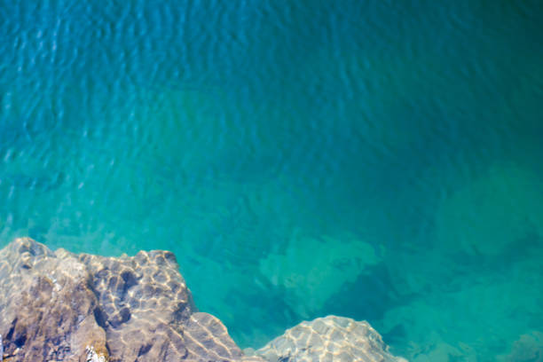 istock Texture of water surface sun water stones waves - underwater world 1159950836