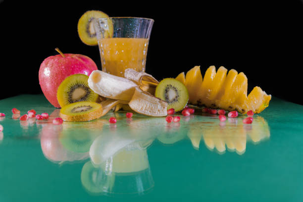 Healthy ingredients for tasty breakfast. Sliced pineapple with bananas, peanuts, peanut butter almonds and sunflower seeds.