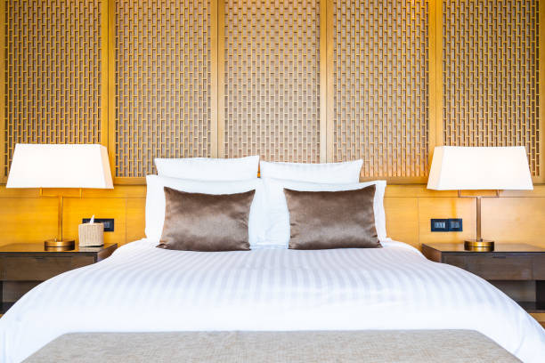 istock Beautiful luxury comfortable white pillow on bed and blanket decoration in bedroom 1159951065